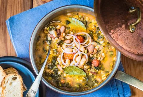 Winter soup with different vegetables, beans, kale, directly above. Stock Photos