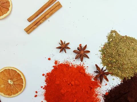 Winter spices flat lay with dried orange and ground spices Stock Photos