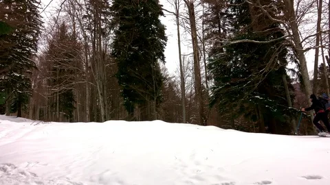 Winter sport activity. Hiking with backpack and snowwhoes Video stock 104085021