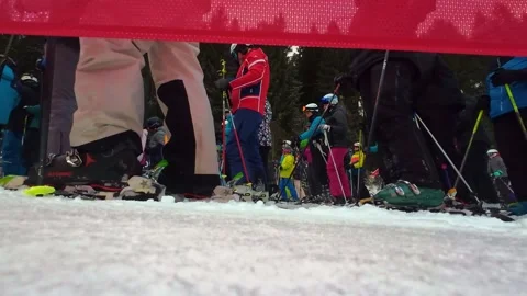 Winter sport tourism crowds queue in lines for ski lift, Low angle Stock Footage 327400357