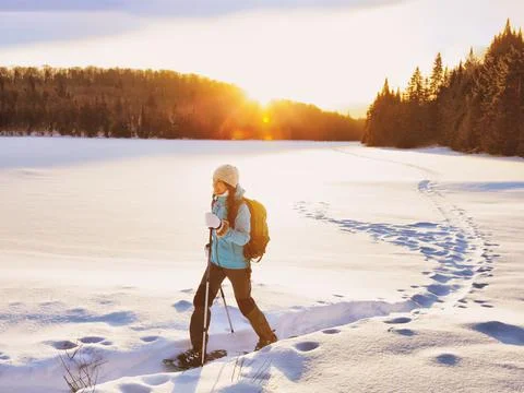 Winter sport woman hiking in snowshoes. Snowshoeing girl in the snow with shoe Stock Photos