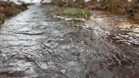 Winter spring water river flow with small bubbles in 4K Stock Footage 231622080