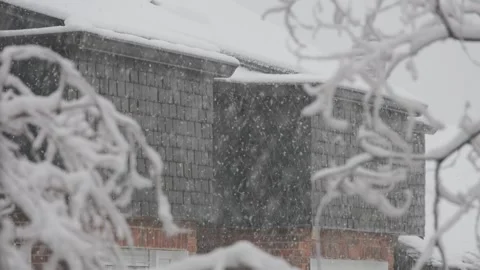 Winter storm and heavy snow falling in a residential neighborhood Stock Footage 346687082