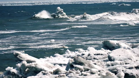Winter storm on the freezing sea. Waves crash against blocks of ice. Stock Footage 165803669