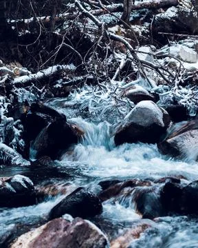 Winter stream. Landscape of cold and frozen river with snow. Cold temperature Stock Photos
