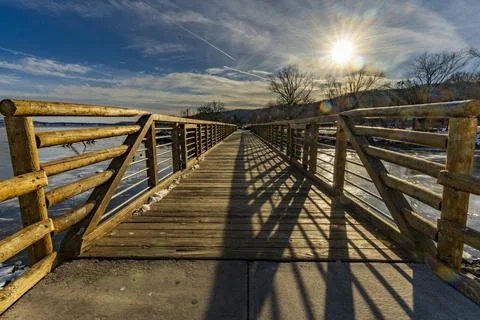 Winter sunlight casts long shadows across the Nyack Memorial Park Inlet Bridge. Stock Photos