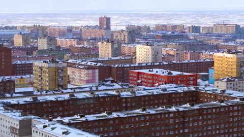 Winter sunlight moving over Norilsk apartment buildings Stock Footage 337021537