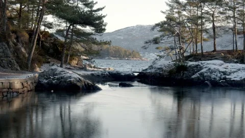  winter sunlight reflecting on the calm waters of an inland lake surrou Stock Footage 233898252