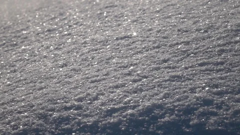 Winter sunny scene with low snowdrift and sparkling flakes in sunshine close up Stock Footage 86042776