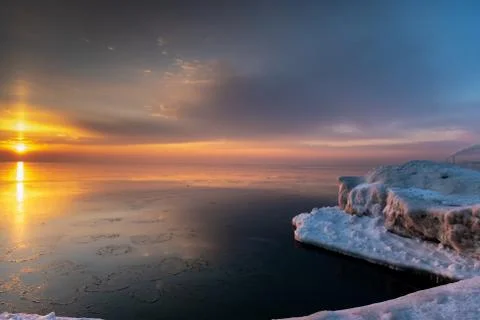 Winter sunrise at the lake shore Stock Photos