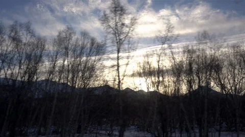 Winter sunset and blue sky against a background of twinkling trees and mountain Stock Footage 62410045