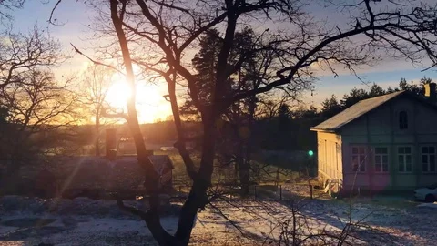 Winter sunset behind an old house and trees Stock-Footage 84305538