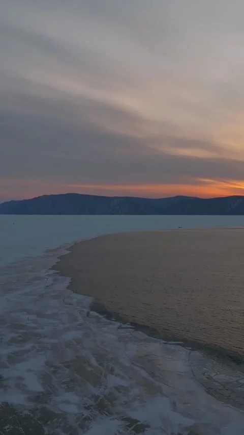 Winter sunset drone view of Listvyanka village on Lake Baikal and Angara River Stock Footage 346556972