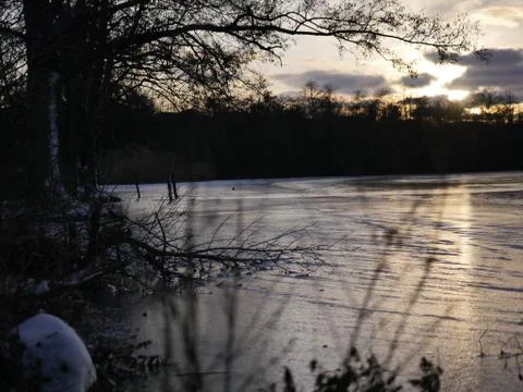 Winter Sunset at a Lake Stock Photos
