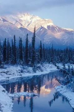 Winter sunset on Miette Range and reflection in a pond along Highway 16 close to Stock Photos