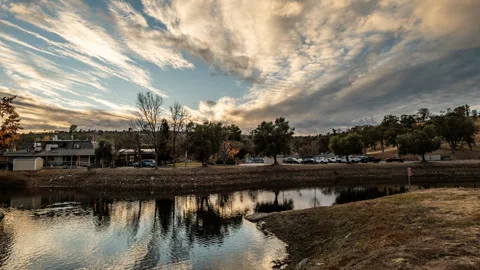 Winter Sunset over Duck Pond and Parking Lot Stock Footage 283976045