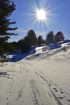 Winter sunset over snowy fields. The snow-white surface of the snow glows in  Stock Photos
