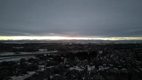 Winter Sunset Rocky Mountains with grey clouds (Crane down) Stock Footage 321768648
