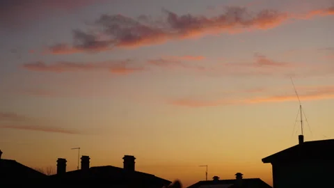 Winter sunset timelapse in between houses silhouettes Stock Footage 265251580