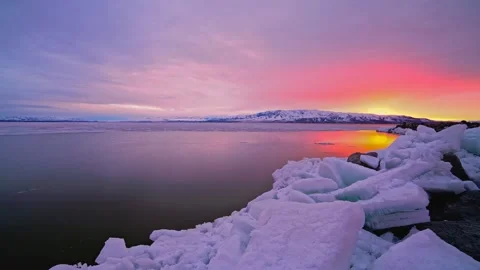 Winter Sunset Timelapse over Frozen Lake and Mountains 動画素材 339136774