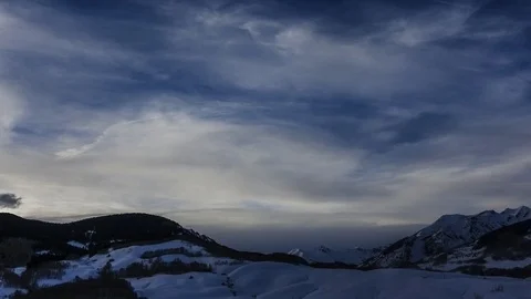 Winter sunset timelapse overlooking mountain peaks Stock Footage 107612714
