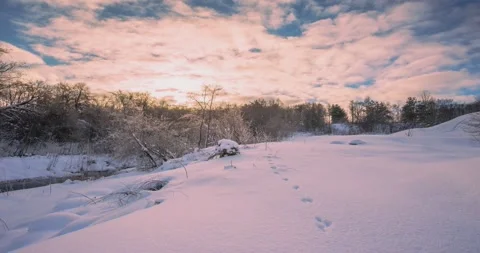 Winter sunset timelapse with snow and river stream in the background Stock Footage