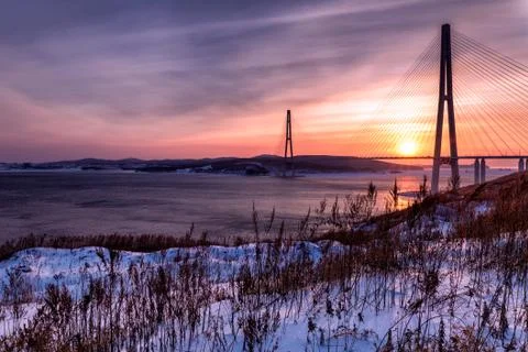 Winter sunset view of long cable-stayed bridge in Vladivostok, Russia Stock Photos