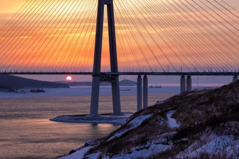 Winter sunset view of long cable-stayed bridge in Vladivostok, Russia Stock Photos