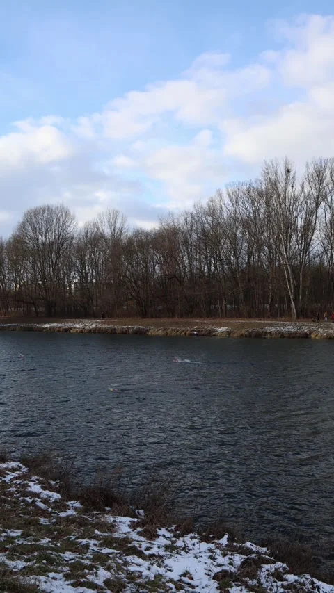 Winter swimmers practicing fast stroke technique in a cold frosty river Stock Footage 329632753