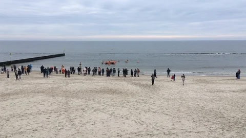 Winter swimming group taking bath in the cold waters of baltic sea 스톡 동영상 119924365