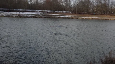 Winter swimming race in cold river Stock Footage 329632147