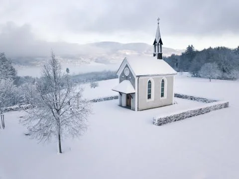 Winter Switzerland fairytale chapel on hill Stock Photos