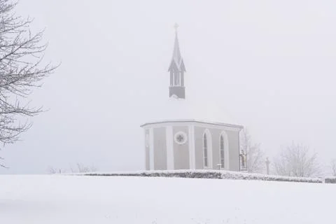 Winter Switzerland fairytale chapel on hill Stock Photos