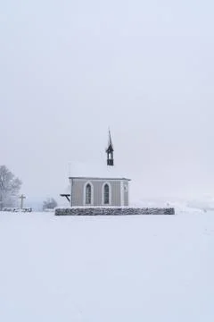Winter Switzerland fairytale chapel on hill Stock Photos