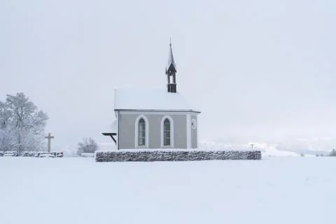 Winter Switzerland fairytale chapel on hill Stock Photos
