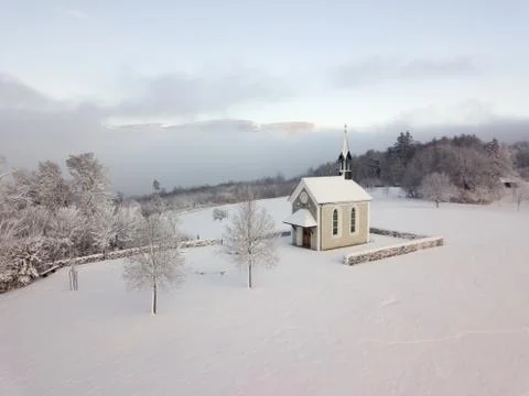 Winter Switzerland fairytale chapel on hill Stock Photos