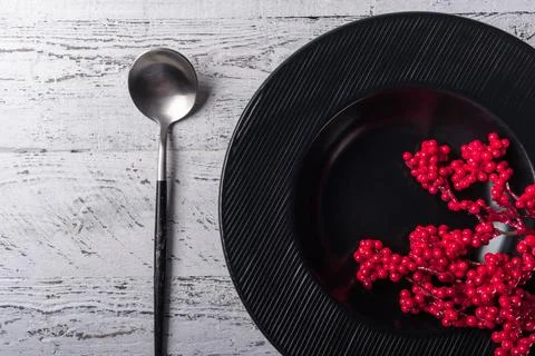Winter table setting with a black deep plate with decorative traditional Ch.. Stock Photos