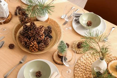 Winter table setting with pine cones and branches in room, top view Stock Photos