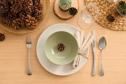 Winter table setting with pine cones in room, top view Stock Photos