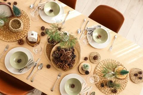 Winter table setting with pine cones and branches in room, top view Stock Photos