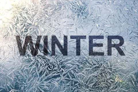 Winter text on frozen patterned glass.on winter window Stock Photos