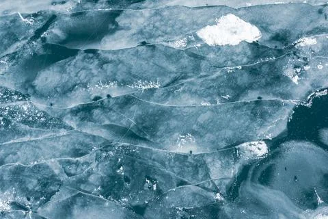 Winter texture drone shot of ice cracks on a frozen lake Stock Photos