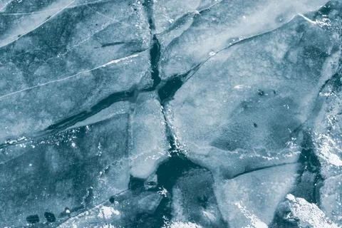 Winter texture drone shot of ice cracks on a frozen lake Stock Photos