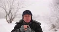 Winter time . Adult man tourist looks for direction on a compass HD Footage