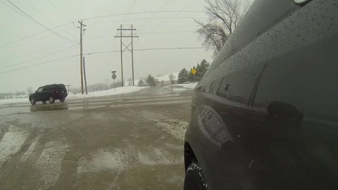 Winter Time Driving - Van Pulls Out on to Wet Street - Snow Fall Stock Footage 101138272