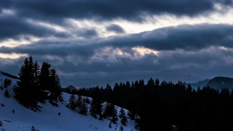 Winter time lapse of sunset in the mountains environment with moving clouds Stock Footage 234744173