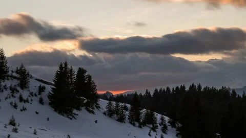 Winter time lapse of sunset in the mountains environment with moving clouds Stock Footage 234744218