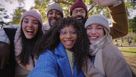 Winter time smiling selfie of a happy group of multicultural friends video call Stock Footage 229862592
