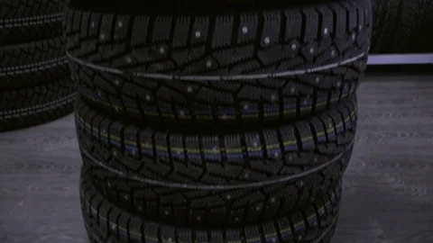 Winter tire on the background of racks with tires. Stock Footage 82582396