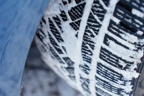 Winter tire tread pattern covered with snow close up Stock Photos